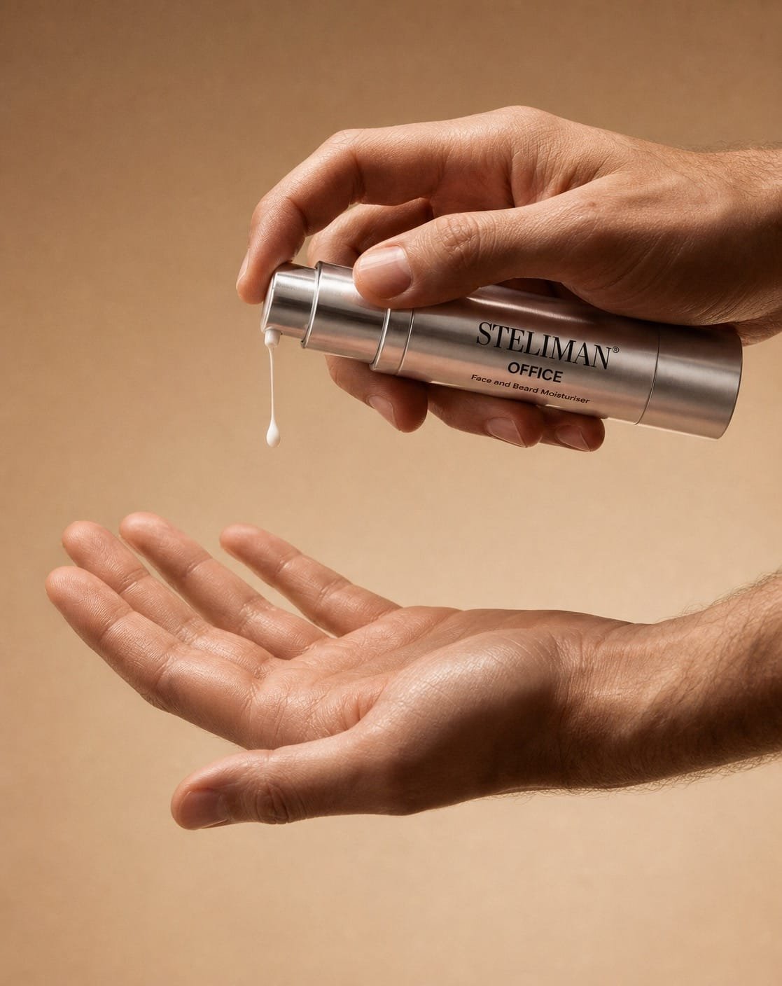 Hands dispensing a silver bottle of Steliman Office moisturizer onto the other palm; label reads 'STELIMAN OFFICE Face and Beard Moisturiser'